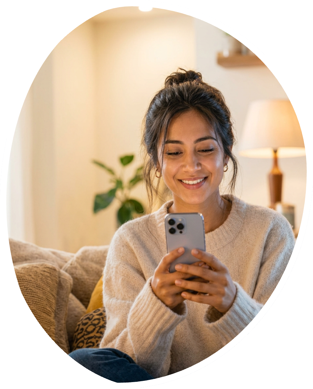 Woman smiling at her phone on the couch